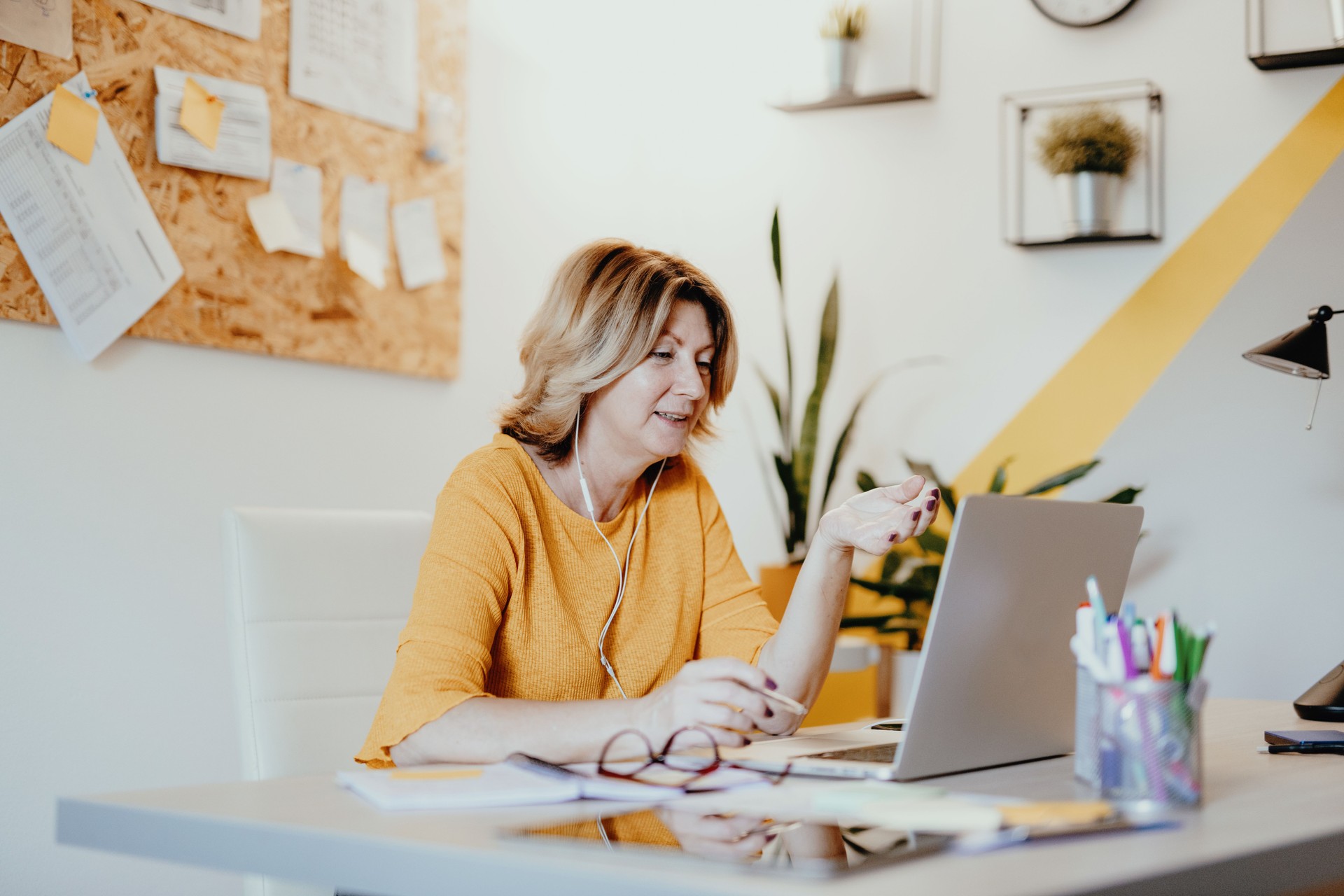 Mature businesswoman telecommuting from home during pandemic to prevent disease