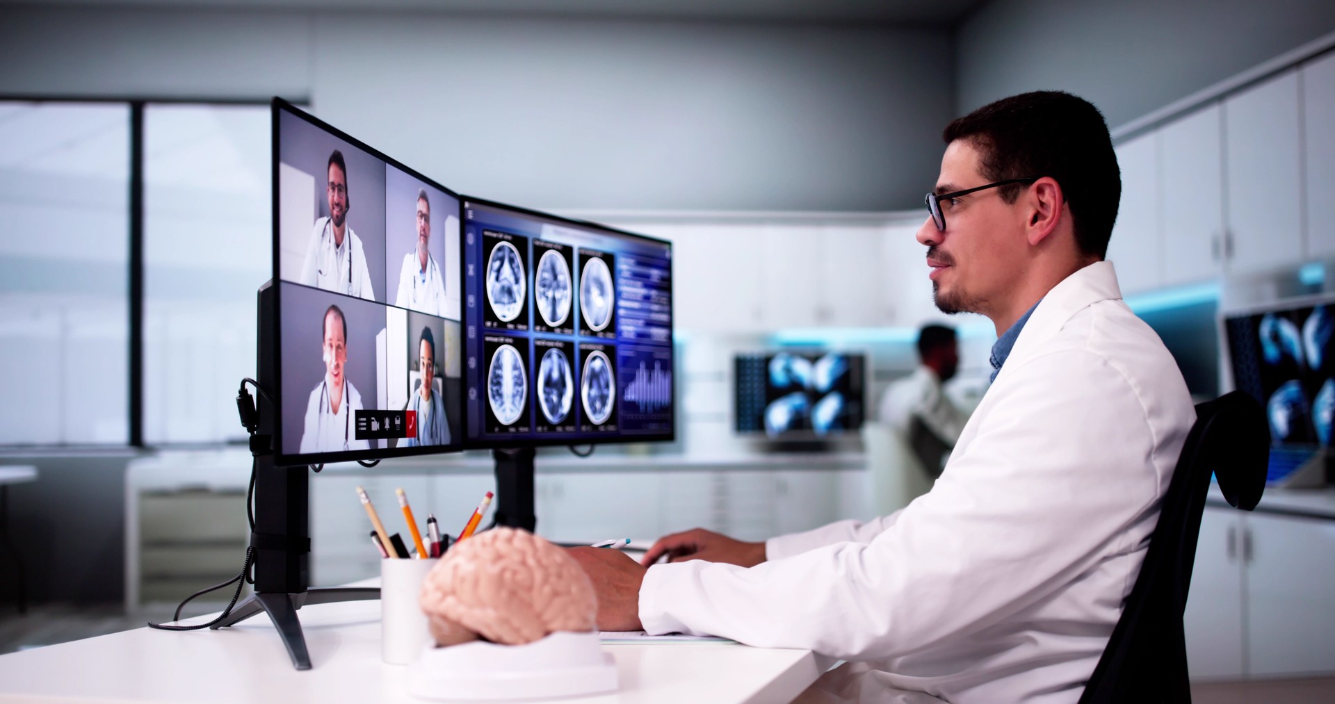 Doctors In Clinic Looking At Brain MRI Scan